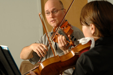 teacher and pupil in violin lesson