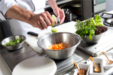 chef preparing ingredients in stainless steel mixing bowl