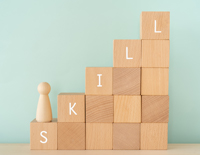 Wooden building blocks spelling the word skill